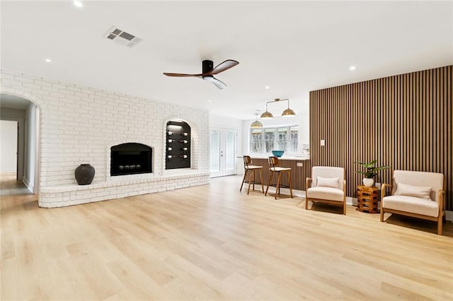 1528 N Cumberland St, Metairie, LA 70003 - living area featuring a ceiling fan, light wood-type flooring, arched walkways, a brick fireplace, and recessed lighting