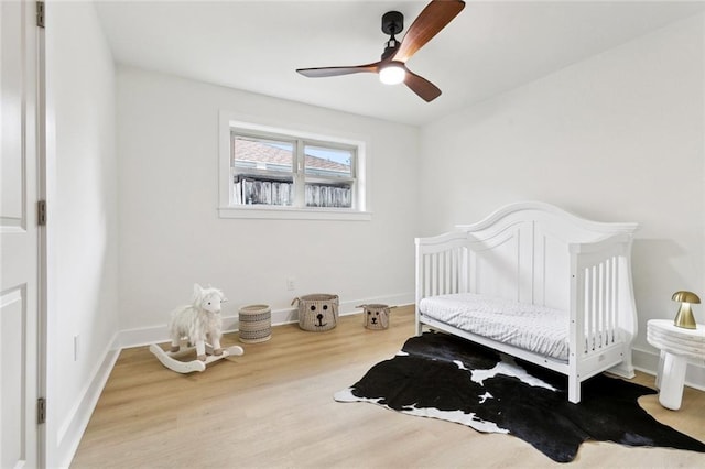 1528 N Cumberland St, Metairie, LA 70003 - bedroom featuring wood finished floors, a ceiling fan, and a crib