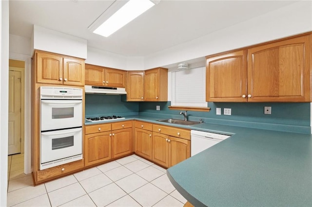 4700 Jasper St, Metairie, LA 70006 - kitchen featuring white appliances, under cabinet range hood, light tile patterned floors, and brown cabinets