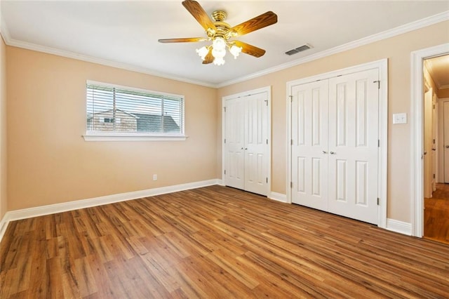 4700 Jasper St, Metairie, LA 70006 - unfurnished bedroom with light wood-type flooring, multiple closets, ornamental molding, and ceiling fan