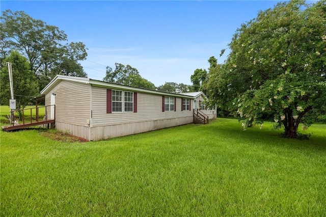 24483 Riley Rd, Pride, LA 70770 - view of side of home featuring a lawn