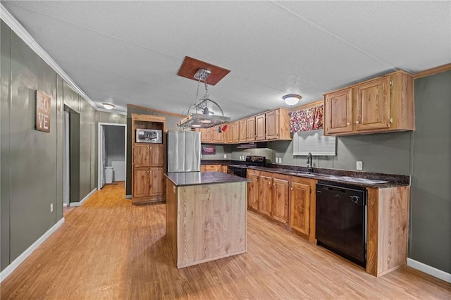 24483 Riley Rd, Pride, LA 70770 - kitchen with black appliances, light wood finished floors, dark countertops, ornamental molding, and a center island