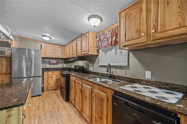 24483 Riley Rd, Pride, LA 70770 - kitchen featuring black appliances, a textured ceiling, light wood-style floors, dark stone countertops, and brown cabinetry
