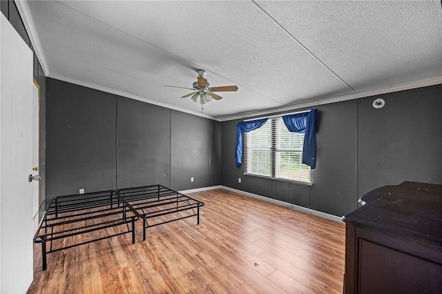 24483 Riley Rd, Pride, LA 70770 - unfurnished bedroom featuring crown molding, a textured ceiling, wood finished floors, and a ceiling fan