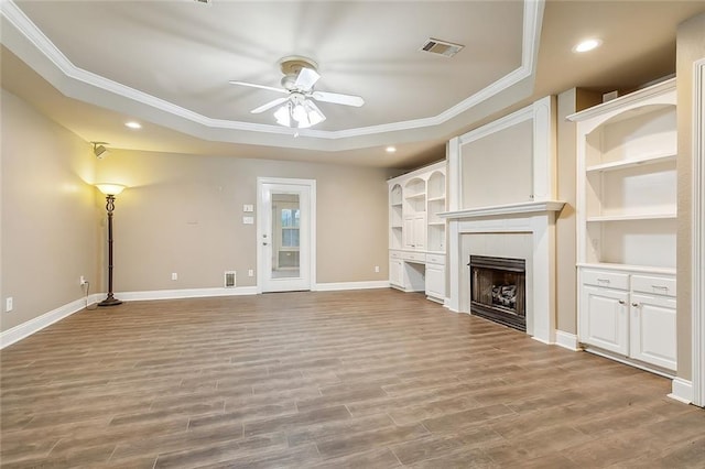 1410 Pecan St, Hammond, LA 70401 - unfurnished living room with ornamental molding, a tray ceiling, a ceiling fan, a fireplace, and recessed lighting