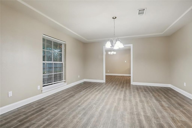 1410 Pecan St, Hammond, LA 70401 - spare room featuring wood finished floors and a chandelier