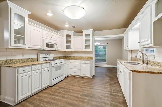 1410 Pecan St, Hammond, LA 70401 - kitchen with white appliances, dark wood-style flooring, decorative backsplash, light stone countertops, and recessed lighting