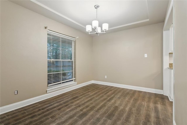 1410 Pecan St, Hammond, LA 70401 - spare room with a tray ceiling, a chandelier, and dark wood finished floors