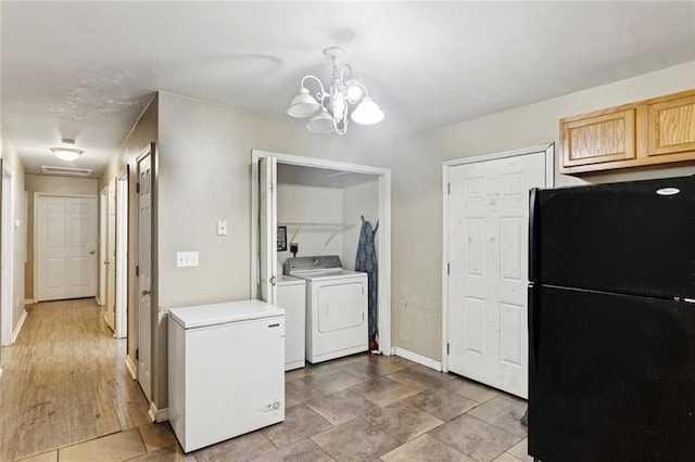 62273 N 12th St, Slidell, LA 70460 - kitchen with freestanding refrigerator, white fridge, washer and dryer, a chandelier, and light countertops