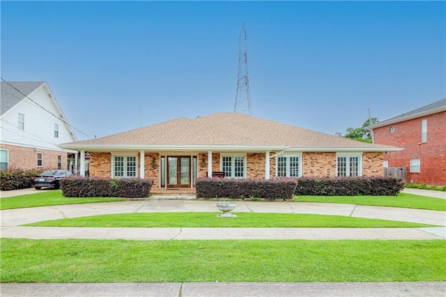 4808 Janice Ave, Kenner, LA 70065 - single story home featuring a front lawn, brick siding, french doors, and curved driveway