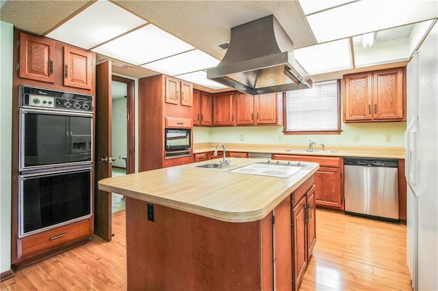 4808 Janice Ave, Kenner, LA 70065 - kitchen with dishwasher, island exhaust hood, light countertops, and light wood-style floors