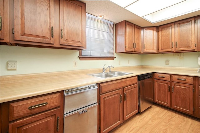 4808 Janice Ave, Kenner, LA 70065 - kitchen with dishwasher, light countertops, brown cabinets, and light wood-style floors