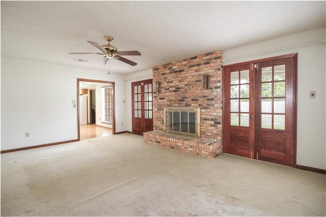 4808 Janice Ave, Kenner, LA 70065 - unfurnished living room with french doors, carpet flooring, a brick fireplace, a ceiling fan, and a textured ceiling