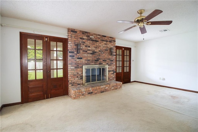 4808 Janice Ave, Kenner, LA 70065 - unfurnished living room featuring french doors, carpet, a textured ceiling, a brick fireplace, and a ceiling fan