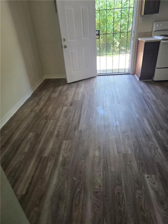 46037 Rufus Bankston Rd, Hammond, LA 70401 - unfurnished dining area featuring dark wood-type flooring and baseboards