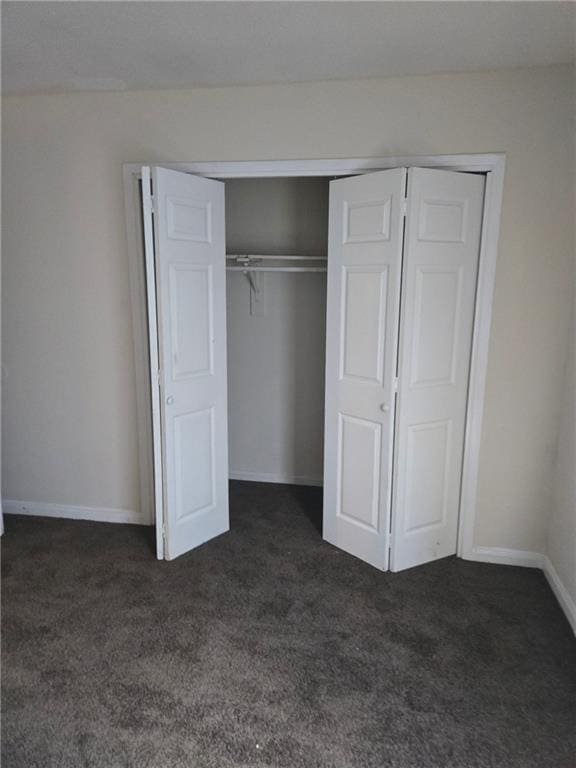 46037 Rufus Bankston Rd, Hammond, LA 70401 - unfurnished bedroom with dark colored carpet and a closet
