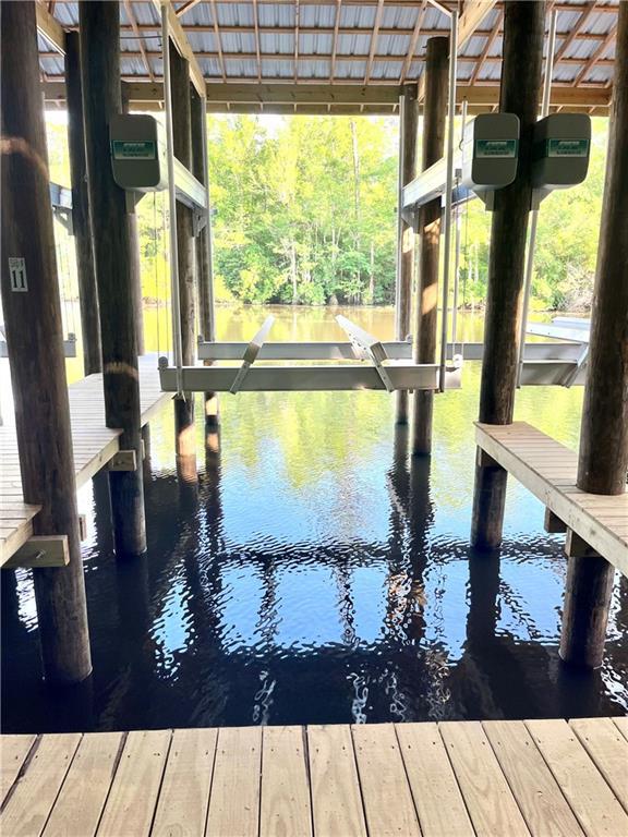 1161 Delta Ln, Covington, LA 70433 - dock with a water view and boat lift
