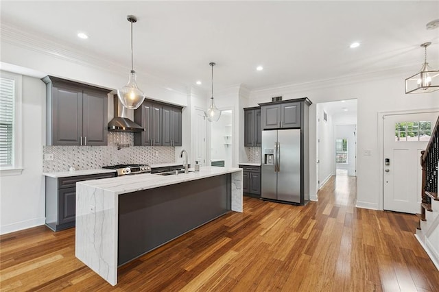 624 Wagner St, New Orleans, LA 70114 - kitchen with stainless steel fridge with ice dispenser, wall chimney range hood, decorative backsplash, gray cabinetry, and wood finished floors