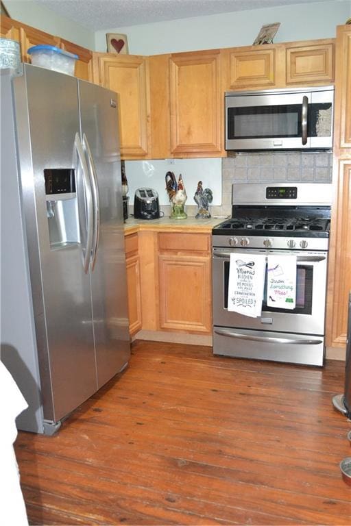 128 Gruner Rd, Metairie, LA 70001 - kitchen featuring stainless steel appliances, light countertops, wood finished floors, backsplash, and light brown cabinetry