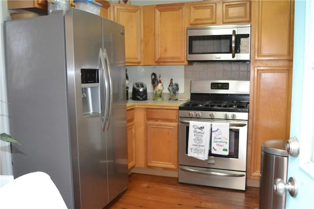 128 Gruner Rd, Metairie, LA 70001 - kitchen featuring appliances with stainless steel finishes, light countertops, wood finished floors, and decorative backsplash