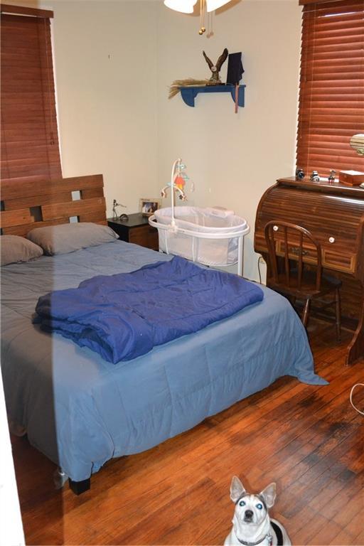 128 Gruner Rd, Metairie, LA 70001 - bedroom featuring wood finished floors and a ceiling fan