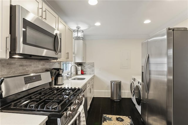 1028 Kerlerec St Unit 3, New Orleans, LA 70116 - kitchen featuring appliances with stainless steel finishes, washing machine and dryer, light countertops, tasteful backsplash, and recessed lighting