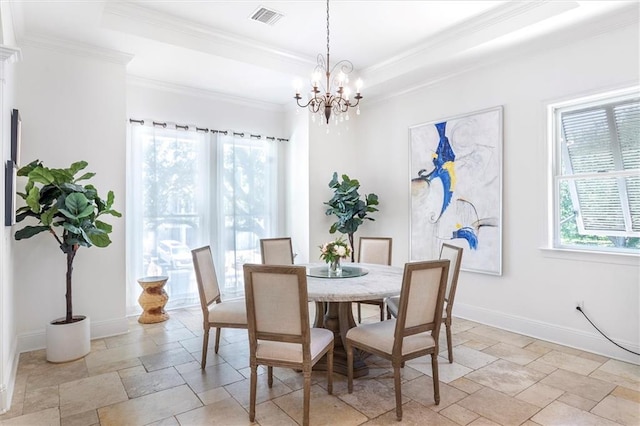 10 Finch St, New Orleans, LA 70124 - dining area featuring stone tile floors, a chandelier, a tray ceiling, and crown molding