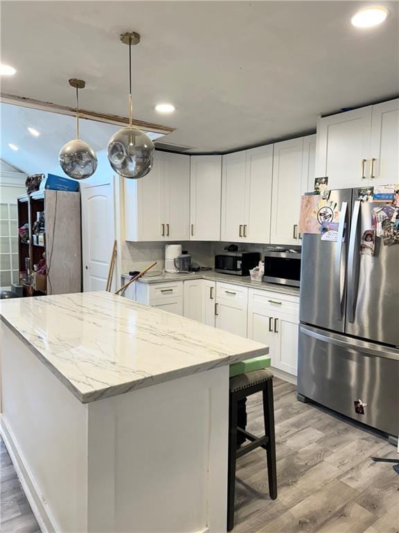 4925 Jasper St, Metairie, LA 70006 - kitchen with stainless steel appliances, light wood-type flooring, white cabinets, and recessed lighting
