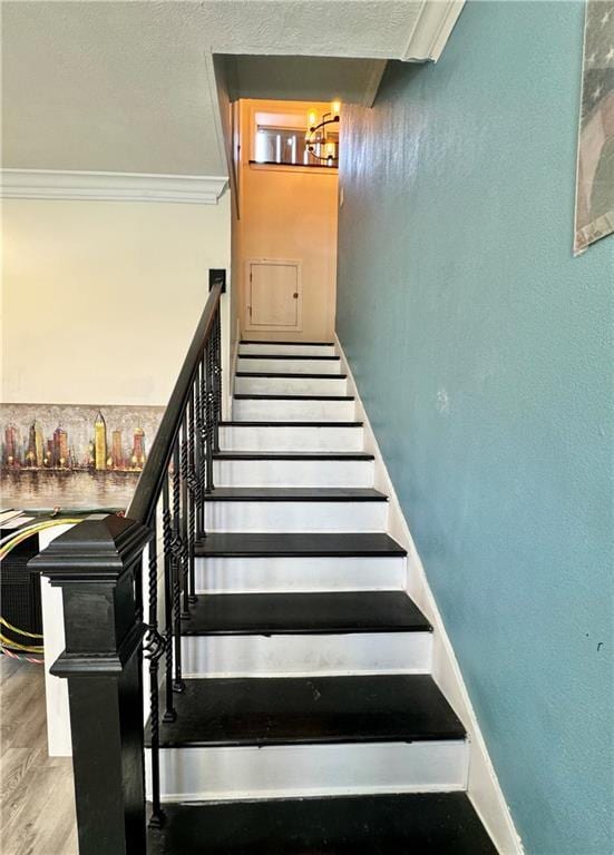 4925 Jasper St, Metairie, LA 70006 - stairs featuring crown molding, wood finished floors, and a chandelier