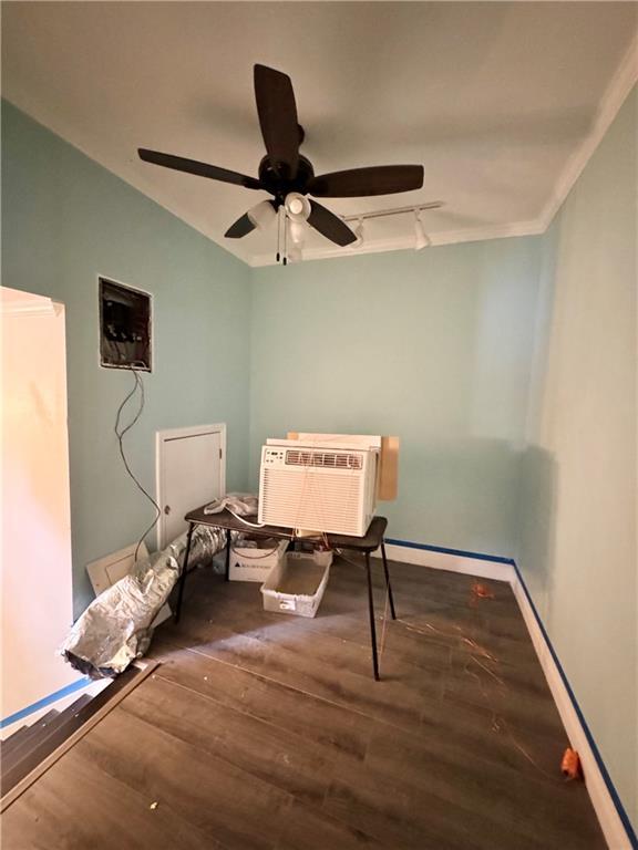 4925 Jasper St, Metairie, LA 70006 - bedroom with wood finished floors, a wall mounted air conditioner, ceiling fan, ornamental molding, and rail lighting