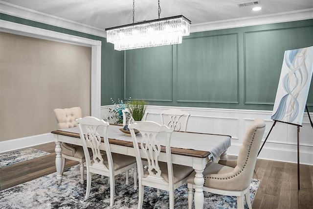 31350 Walker Rd, Walker, LA 70785 - dining area featuring wood finished floors, a chandelier, crown molding, and a decorative wall