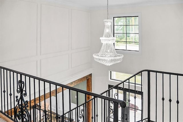 31350 Walker Rd, Walker, LA 70785 - stairway featuring a chandelier, plenty of natural light, and crown molding