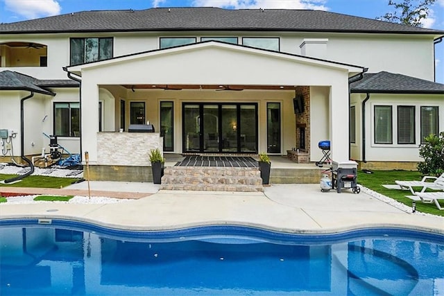 31350 Walker Rd, Walker, LA 70785 - back of property featuring a ceiling fan, a patio area, stucco siding, and an outdoor pool