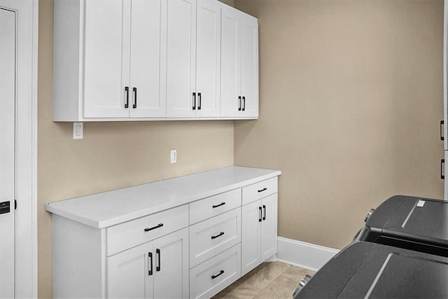 31350 Walker Rd, Walker, LA 70785 - laundry area with washing machine and dryer, cabinet space, and light marble finish flooring