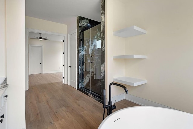 3028 Sunrise Blvd, Slidell, LA 70461 - full bath with a stall shower, a freestanding tub, and wood finished floors