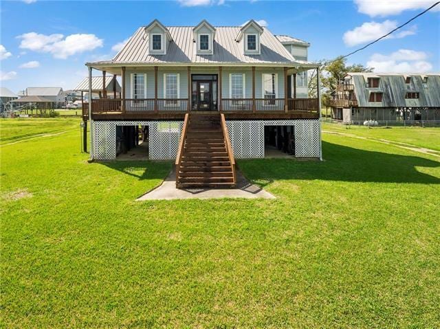 30 Clinton Dr, New Orleans, LA 70129 - back of house with stairs, covered porch, a lawn, and a metal roof