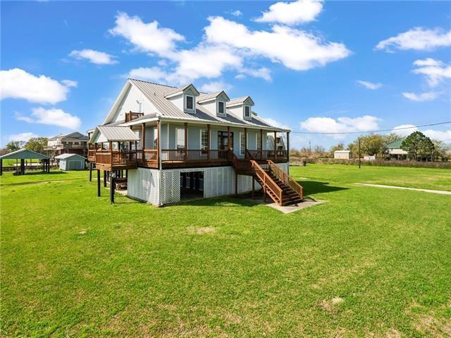 30 Clinton Dr, New Orleans, LA 70129 - back of house featuring stairs, a yard, and a wooden deck