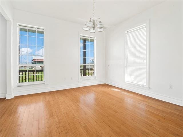 30 Clinton Dr, New Orleans, LA 70129 - spare room with a chandelier and light wood-style floors