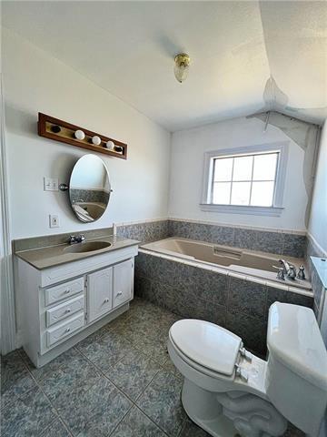 30 Clinton Dr, New Orleans, LA 70129 - bathroom with a bath, vanity, and tile patterned flooring