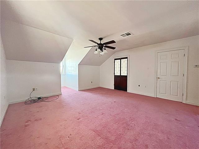 30 Clinton Dr, New Orleans, LA 70129 - additional living space featuring a ceiling fan, lofted ceiling, and carpet floors