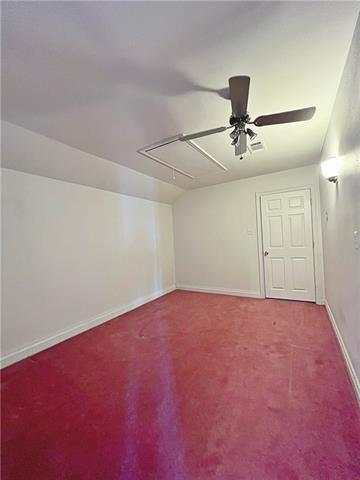 30 Clinton Dr, New Orleans, LA 70129 - carpeted spare room with attic access, a ceiling fan, and vaulted ceiling