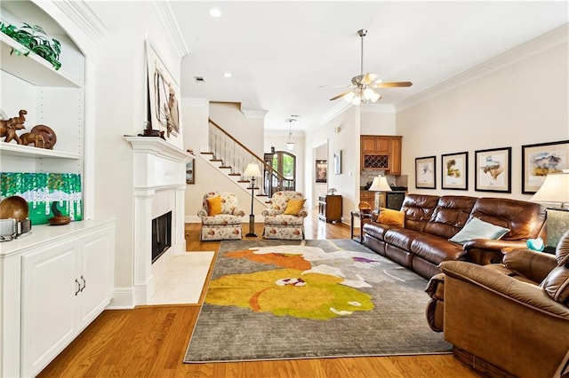 356 Aspen Ln, Covington, LA 70433 - living room with ornamental molding, light wood-style floors, ceiling fan, a fireplace, and recessed lighting
