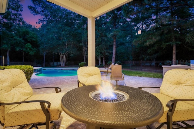 356 Aspen Ln, Covington, LA 70433 - view of swimming pool with a patio area, an outdoor fire pit, outdoor dining space, and view of wooded area