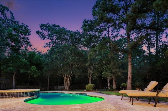 356 Aspen Ln, Covington, LA 70433 - pool at dusk featuring a fenced backyard, a patio area, and view of scattered trees