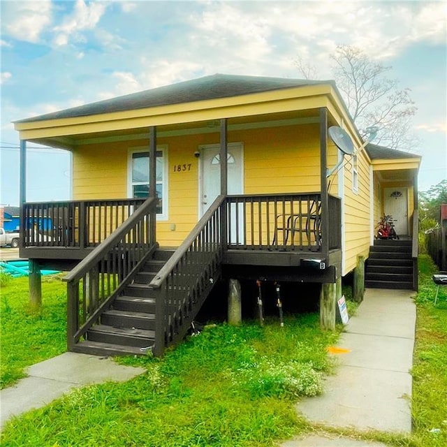 1837 Charbonnet St, New Orleans, LA 70117 - view of front of home with covered porch, stairs, and a front yard