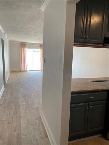 3805 Houma Blvd Unit B304, Metairie, LA 70006 - hall featuring a textured ceiling, light wood-style flooring, and ornamental molding
