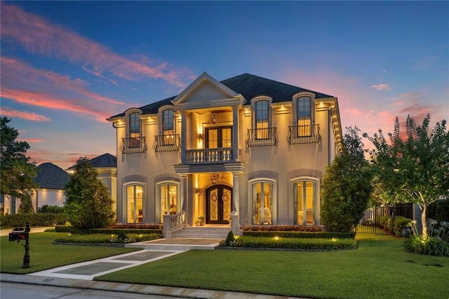21 Royal Palm Dr, Kenner, LA 70065 - french provincial home with a balcony, french doors, and stucco siding