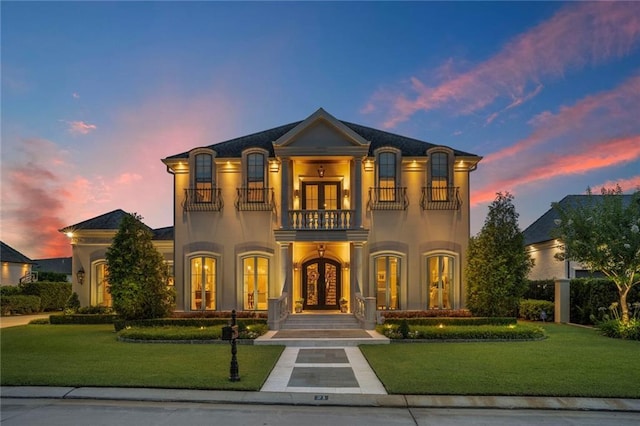 21 Royal Palm Dr, Kenner, LA 70065 - french country style house with a balcony, french doors, a lawn, and stucco siding