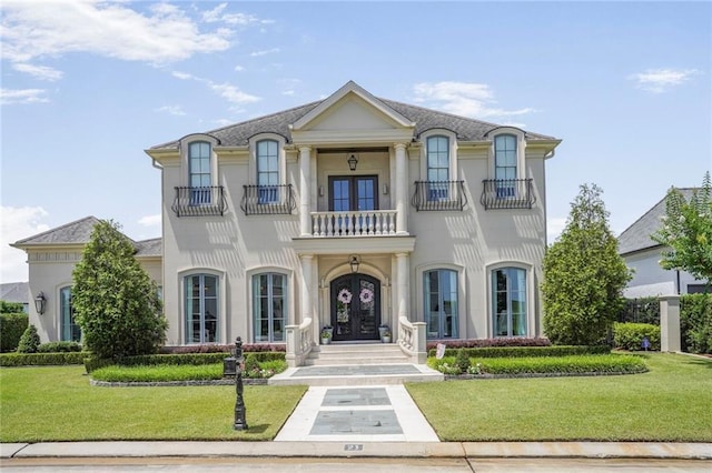 21 Royal Palm Dr, Kenner, LA 70065 - french provincial home featuring a balcony, french doors, a front yard, and stucco siding