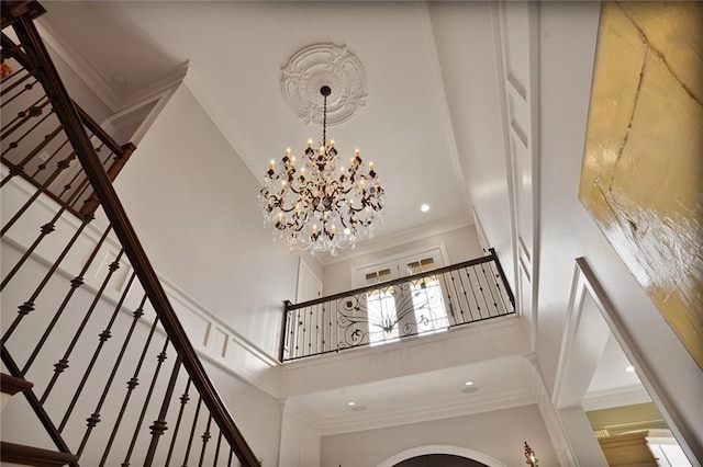 21 Royal Palm Dr, Kenner, LA 70065 - stairway featuring a high ceiling, crown molding, a chandelier, and recessed lighting
